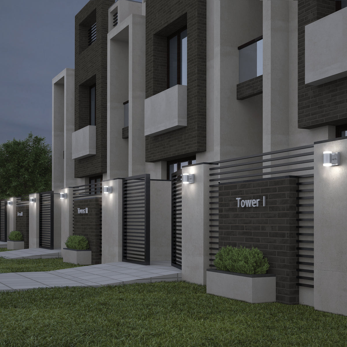 Modern townhouse complex at dusk featuring Neo LED Indoor/Outdoor Wall Light Stainless illuminating dark brick and concrete walls, metal gates labeled Tower I, potted plants, and a neatly trimmed lawn.