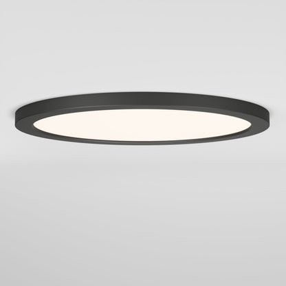 The Skylight Pro 15" 5K LED Flat Panel Light is a round, ultra-slim ceiling fixture with a black frame and white illuminated center, offering adjustable brightness and seamlessly mounted on a plain white ceiling.