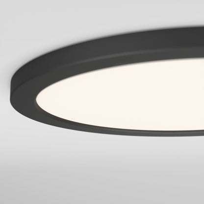 A close-up view of the Skylight Pro 15" 5K LED Flat Panel Light, showcasing its ultra-slim design, black rim, bright diffused light, and adjustable brightness for customizable ambiance on a plain white ceiling.